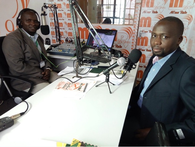 Geoffrey Kerosi and Kamadi Amata of Mtaani Radio discussing projects funded by Nairobi City Ward Development Fund 