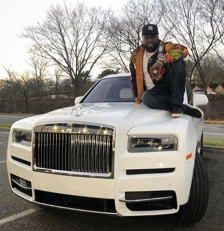 Rapper 50 Cent relaxing on his newly acquired Rolls Royce- a Christmas Grift for himself. 