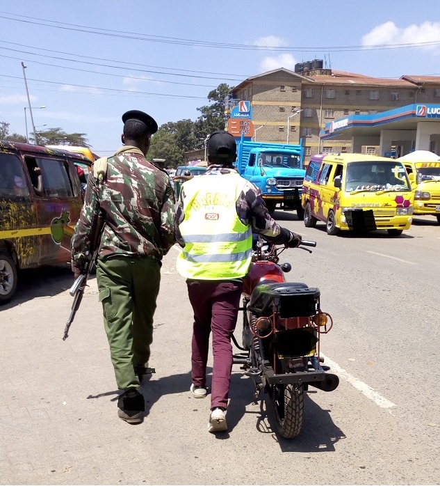 Boda boda rider and a police officer matching to the police station