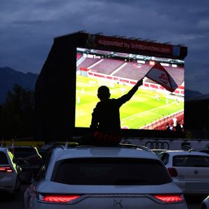 Some fans watched the game from their cars at a drive-in viewing.