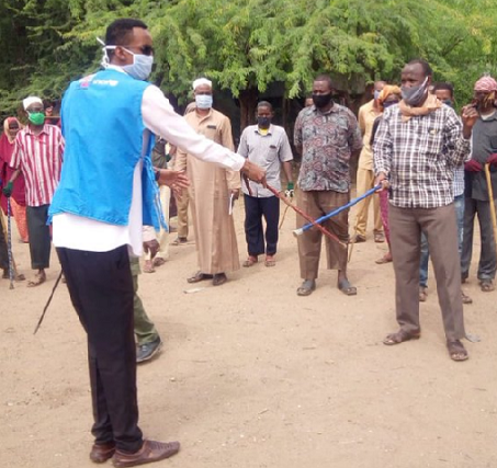Kenyan goat traders dump handshake for stick-shake
