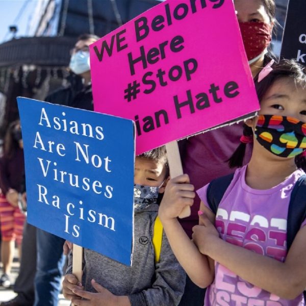 “Asians are not viruses, Racism is,” placard read