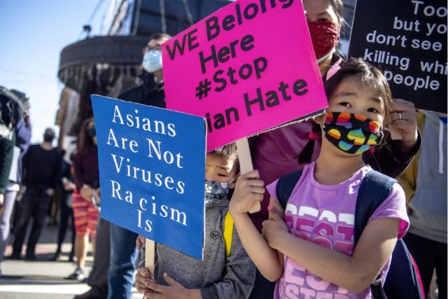 “Asians are not viruses, Racism is,” placard read