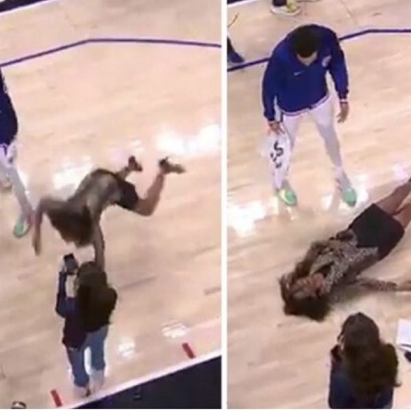 Journalist on duty falls and lands on basketball court after slipping on water