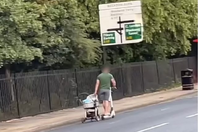 Man seen riding an e-scooter and pulling a pram along a highway  in London