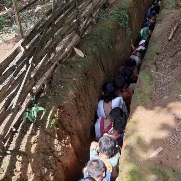 Children hide in a pit due to airstrikes in Myanmar
