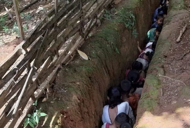 Children hide in a pit due to airstrikes in Myanmar