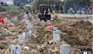Earthquake photos show mass graves marked with just numbers as deaths hit 25,000